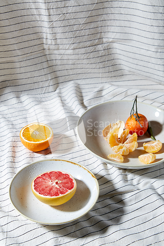 Image of still life with mandarins and grapefruit on plate