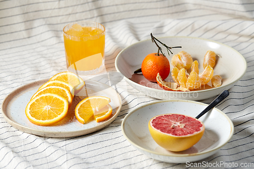 Image of mandarin, grapefruit and glass of orange juice