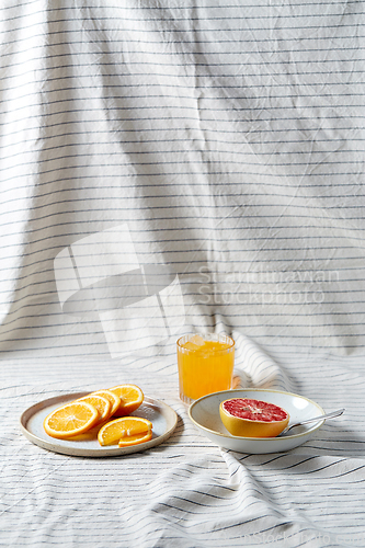 Image of grapefruit, sliced orange and glass of juice