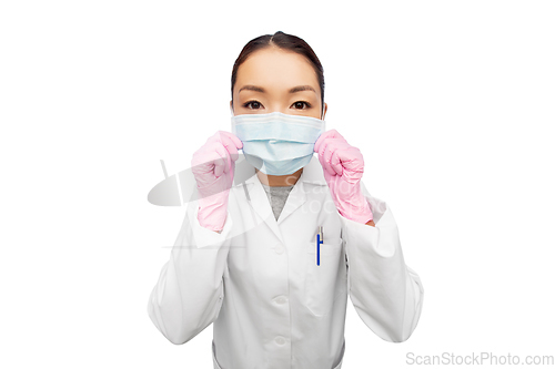 Image of asian female doctor in medical mask and gloves