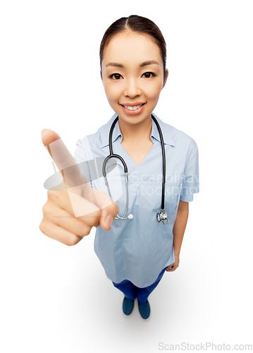 Image of happy asian female doctor pointing to camera