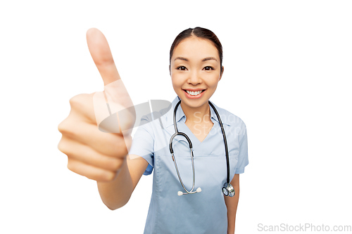 Image of smiling asian female doctor showing thumbs up