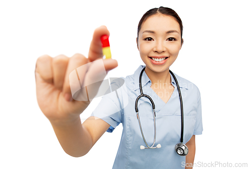 Image of asian doctor with medicine and glass of water