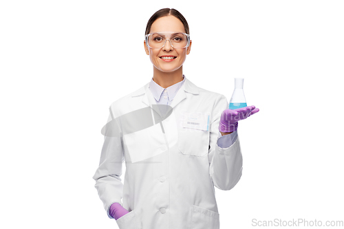 Image of female scientist in goggles with chemical in flask