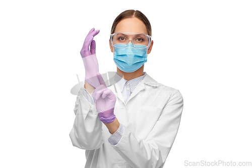 Image of female doctor in gloves, mask and goggles