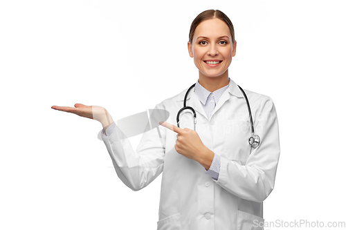 Image of happy female doctor holding something on her hand
