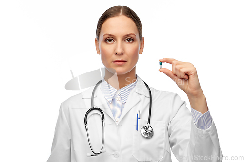 Image of female doctor holding medicine pill