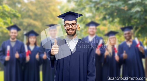 Image of happy male graduate student showing thumbs up