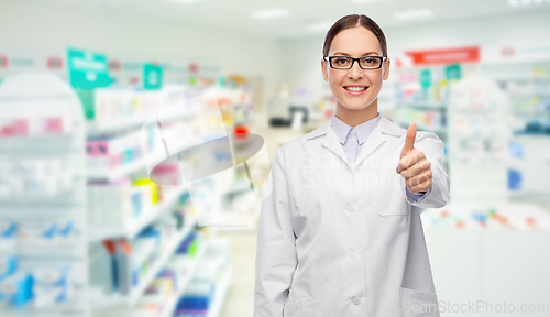 Image of female pharmacist showing thumbs up at pharmacy