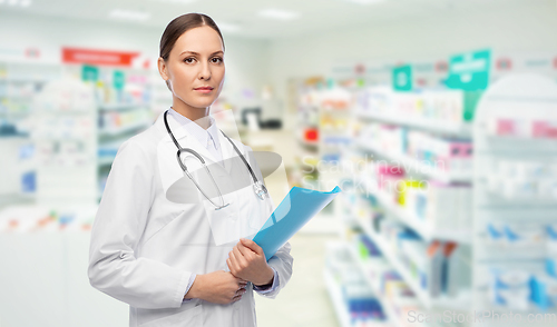 Image of doctor with folder and stethoscope at pharmacy