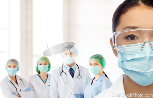 Image of asian female doctor in medical mask at hospital