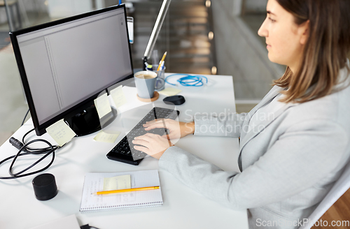 Image of businesswoman with computer working at office