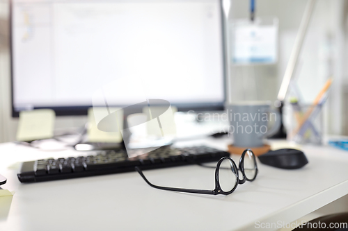 Image of laptop computer and gadgets on table at office