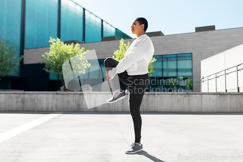 Image of african american woman doing sports outdoors