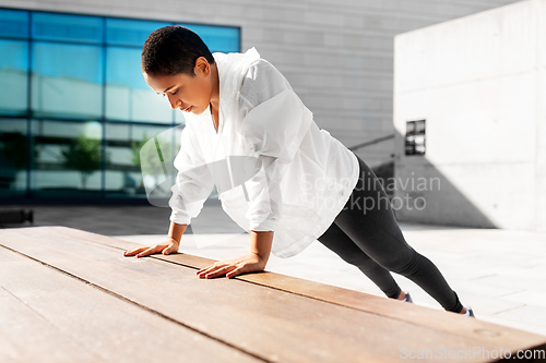 Image of african american woman doing sports outdoors