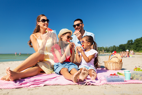 Image of happy family having picnic on summer beach