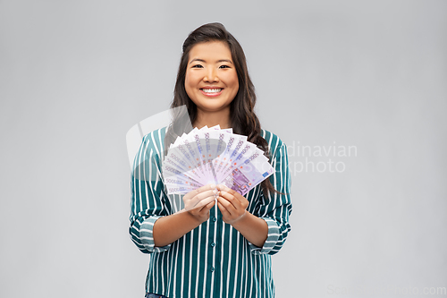 Image of asian woman with money banknotes of thousands euro