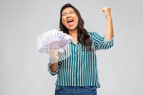 Image of happy asian woman with money celebrating success