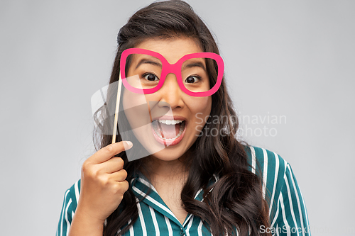 Image of happy asian woman with big party glasses