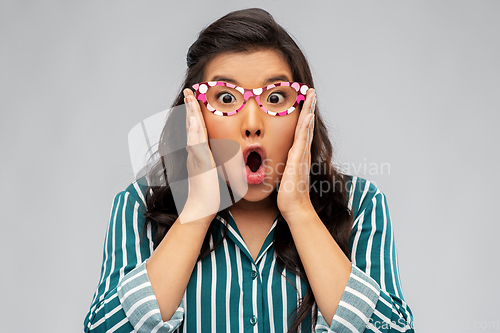 Image of surprised asian woman with party glasses