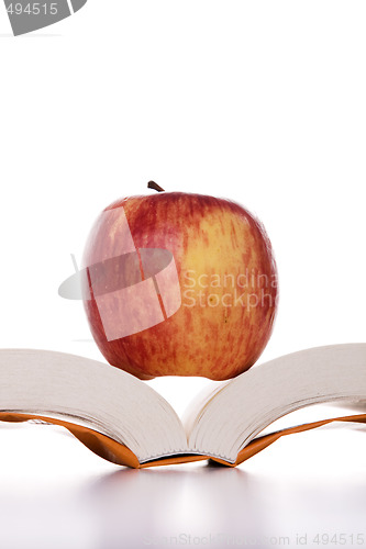 Image of apple over a open book 