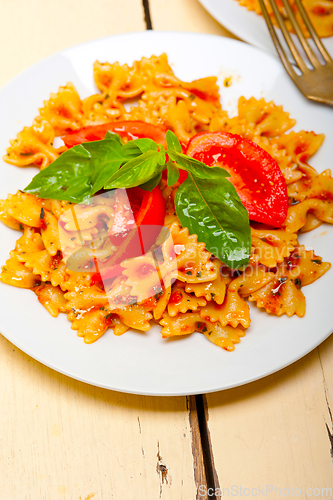 Image of Italian pasta farfalle butterfly bow-tie and tomato sauce