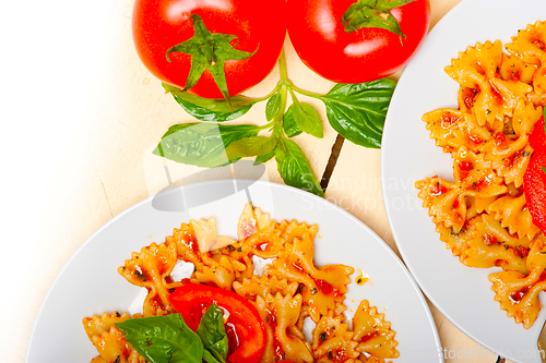 Image of Italian pasta farfalle butterfly bow-tie and tomato sauce