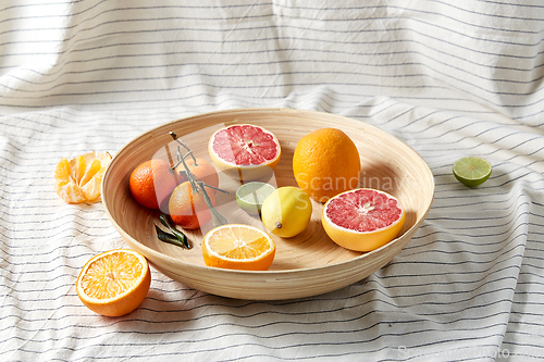 Image of close up of citrus fruits on wooden plate