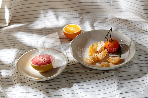 Image of still life with mandarins and grapefruit on plate