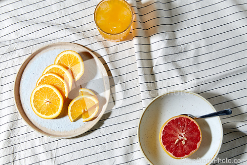 Image of grapefruit, sliced orange and glass of juice