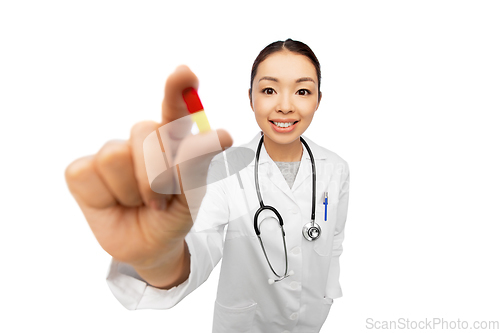 Image of asian doctor with medicine and glass of water