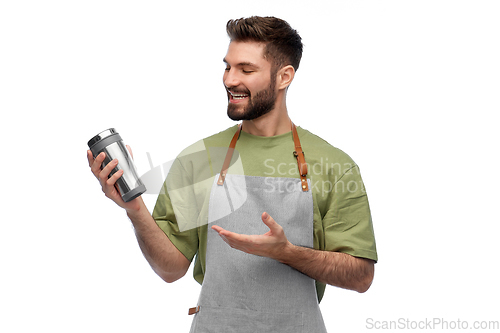 Image of happy waiter with tumbler or takeaway thermo cup