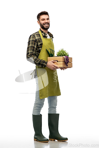 Image of happy gardener or farmer with box of garden tools