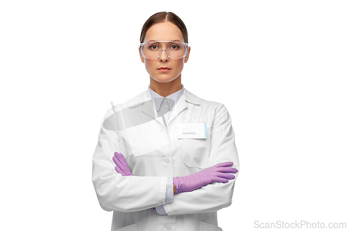 Image of female scientist in goggles and gloves