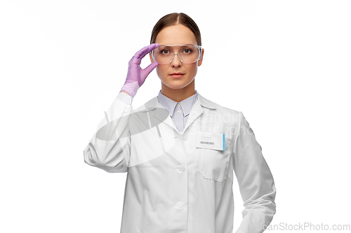 Image of female scientist in goggles and gloves