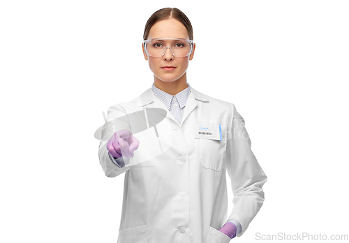 Image of female scientist in goggles pointing to camera