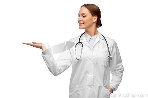 Image of happy female doctor holding something on her hand