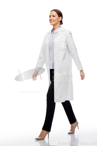 Image of smiling female doctor or scientist walking