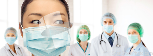 Image of close up of asian doctor in mask at hospital