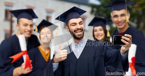 Image of graduate students with smartphone taking selfie