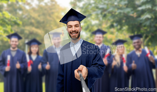 Image of male graduate student taking selfie with monopod