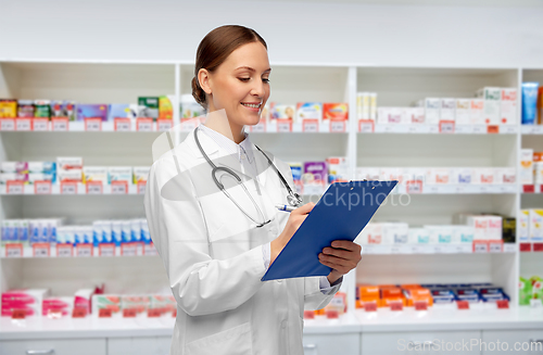 Image of happy smiling female doctor with clipboard