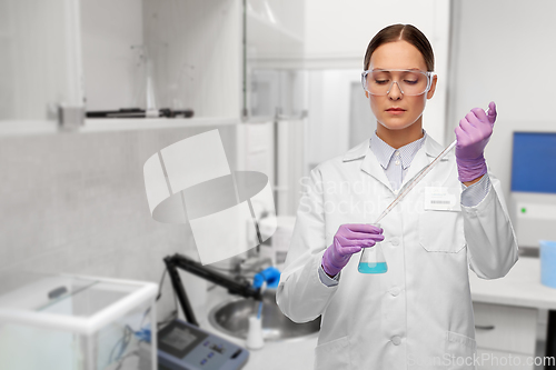 Image of female scientist with chemical at laboratory