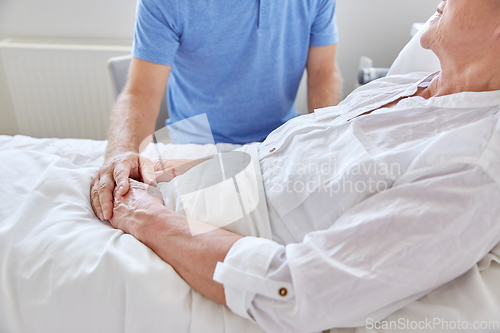 Image of senior couple meeting at hospital ward