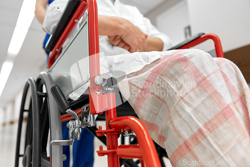 Image of nurse with senior patient in wheelchair at clinic