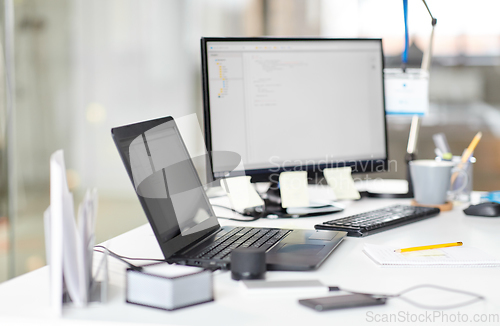 Image of laptop computer and gadgets on table at office