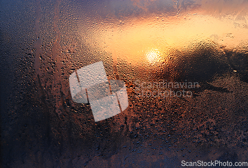 Image of Melting ice, water drops and sunlight in a winter morning on gla