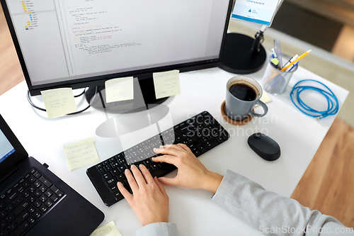 Image of businesswoman with computer working at office