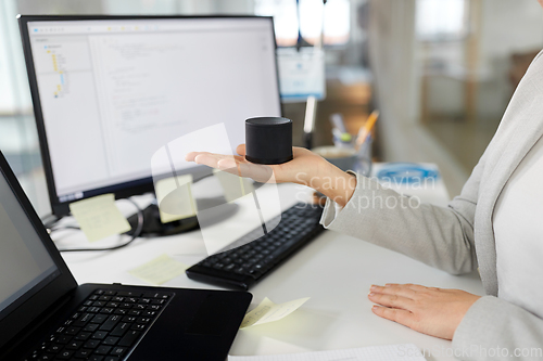 Image of businesswoman using smart speaker at office