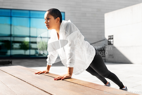 Image of african american woman doing sports outdoors